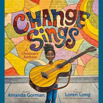 The cover art depicts a scene with a child, holding a musical instrument, specifically a guitar. The guitar and the child are the central figures of the poster-like art on the book cover. The child is standing on a footpath and behind them are the title of the book and a mural on the brickwork with vibrant colours and geometric shapes.
