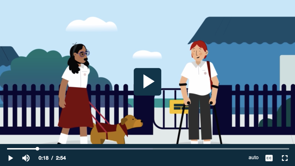 Still from an animated video with the play button in the middle. A boy and a girl in school uniforms meeting outside a fenced schoolyard. The girl has shoulder length curly pigtails, glasses and brown skin. She has a guide dog in it's harness. The boy has short red hair and fair skin. He is wearing a backpack and using crutches.