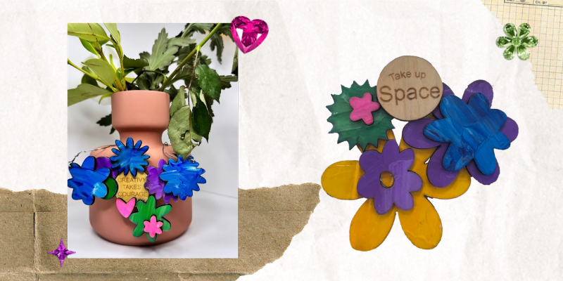 A photo of Zoe’s artwork; a vase with leaves in it. Around the vase are painted wooden flower shapes. They are painted in marbled colours of blue, purple, green, and pink. In the centre is a circular piece of wood with the quote ‘creativity takes courage’ printed on it. A photo of another wooden art piece that includes flower shapes stacked together and painted in marbled colours of blue, purple, yellow, pink, and green. Another circular piece of wood has the quote “Take up space” printed on it.