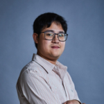 Headshot of Adam, a young Asian man who is wearing glasses and a button up shirt.