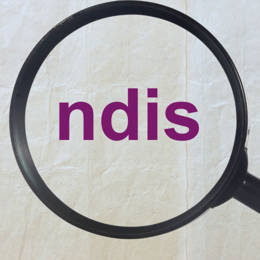 Purple text on a crumpled piece of paper under a magnifying glass reads: "NDIS".